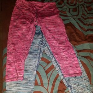 Two pairs of Reebok capris workout pants.